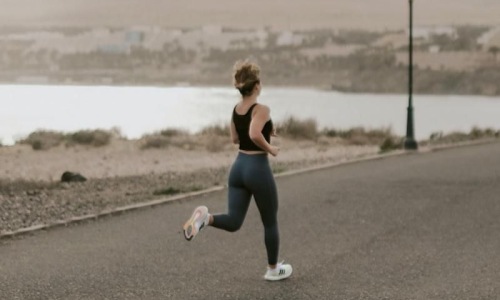 a woman running on a road