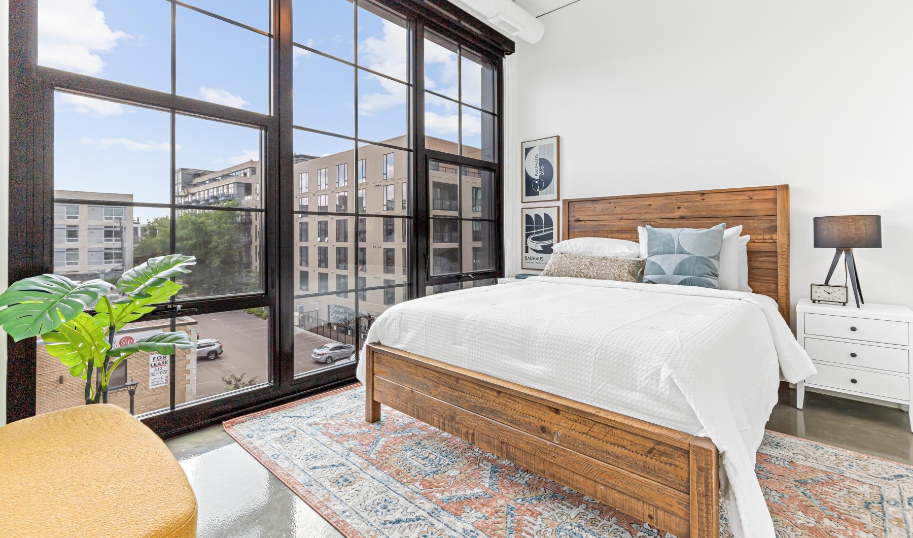 a bedroom with a large window