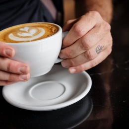 a coffee being held 