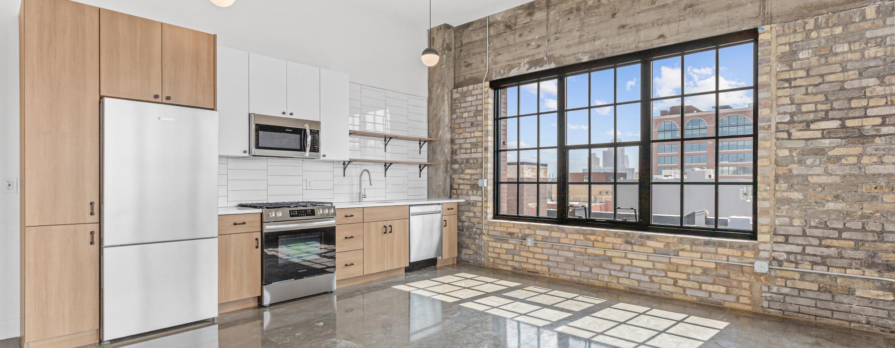 a kitchen with a brick wall