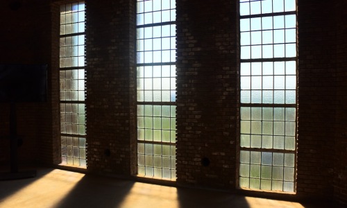 Loft apartments Minneapolis interior with exposed brick and large windows - loft apartments Minneapolis