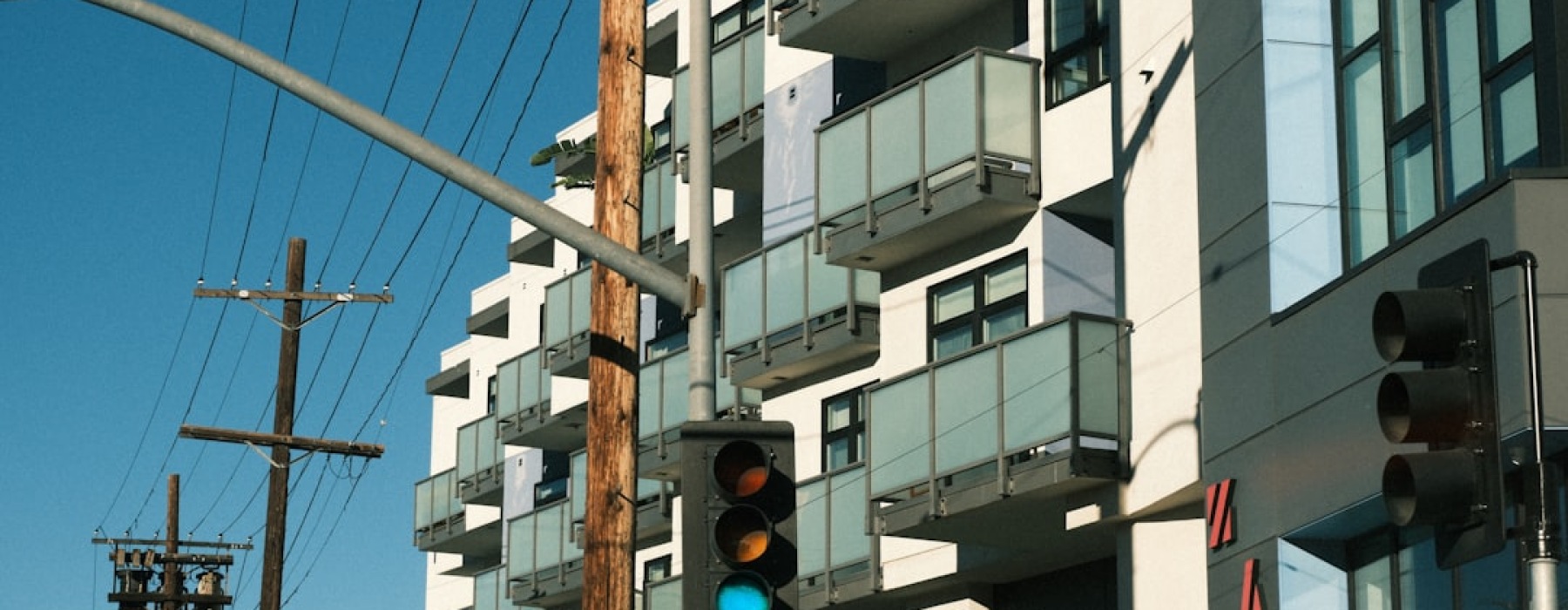 modern apartment building with electric vehicle charging station - apartments with EV charging