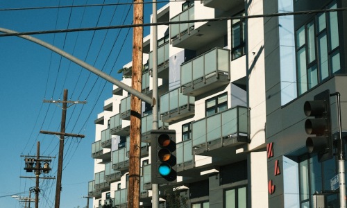 modern apartment building with electric vehicle charging station - apartments with EV charging
